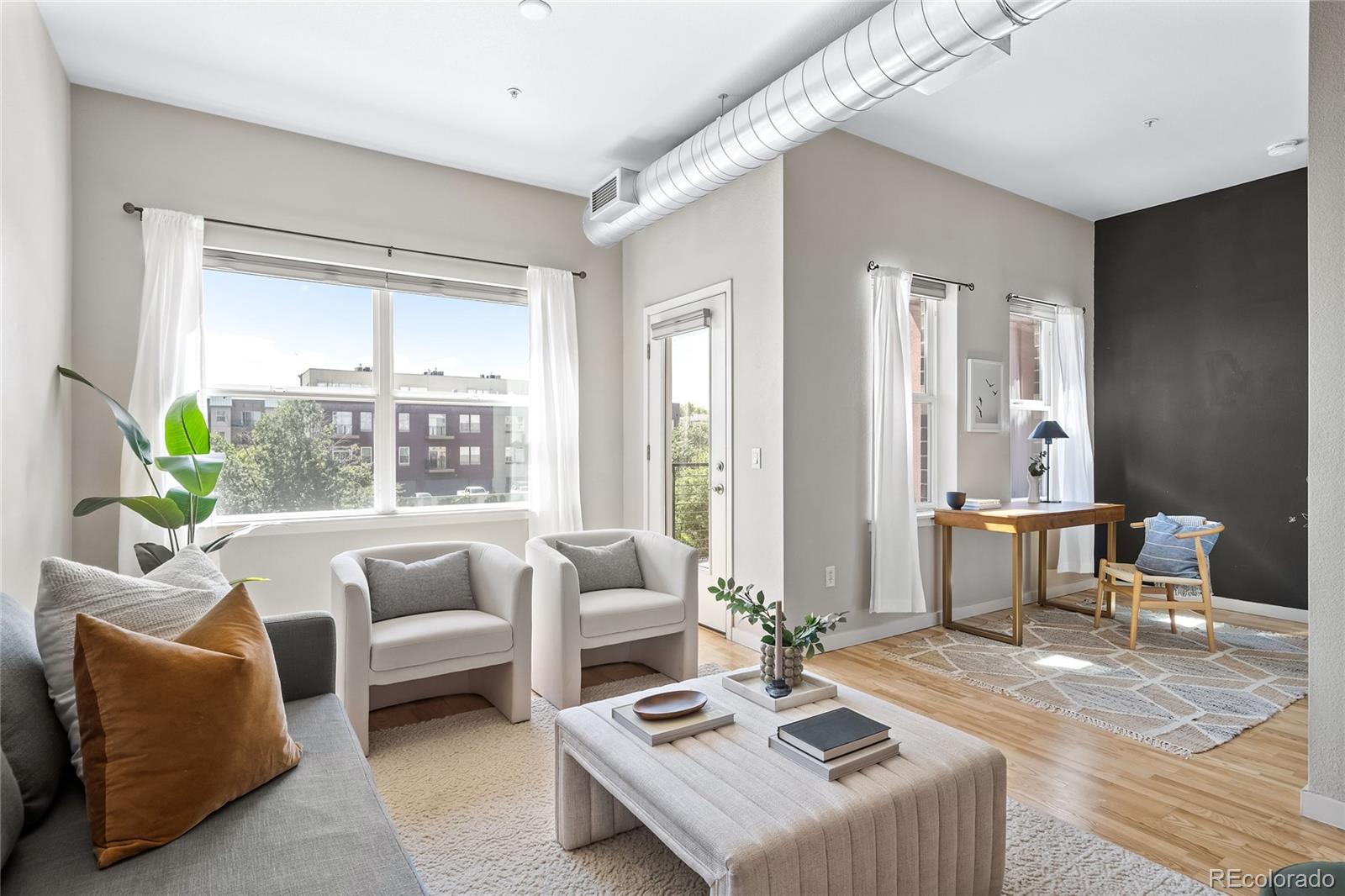 a living room with furniture and a large window