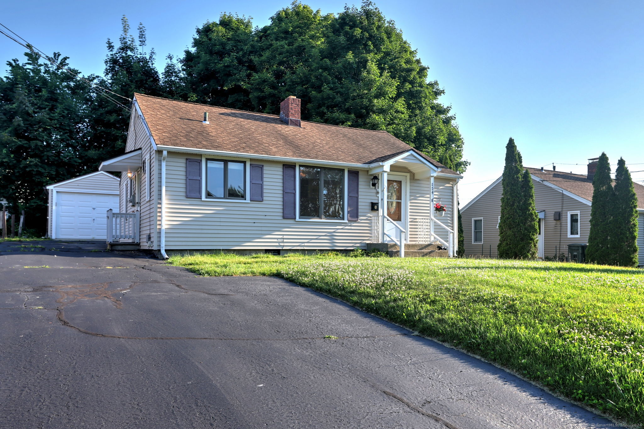 a front view of house with yard and green space