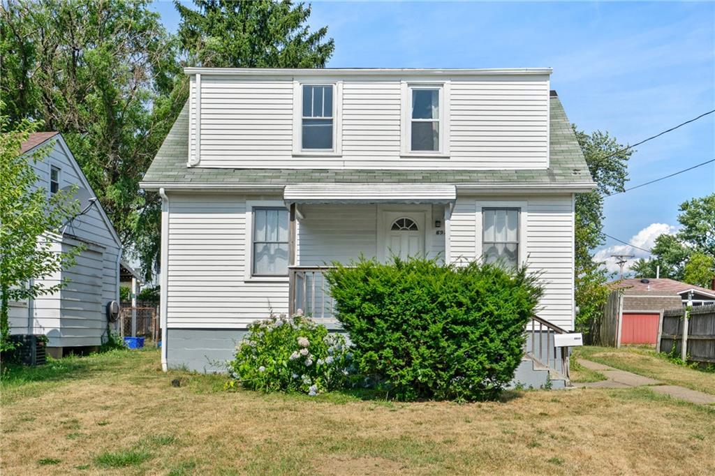 a view of a house with a yard and plants