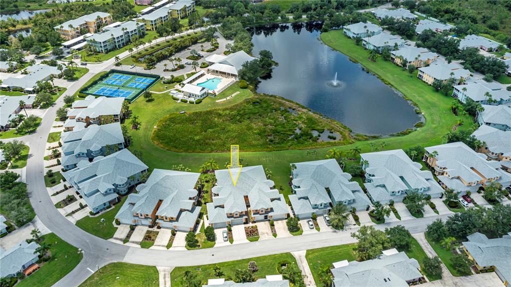 an aerial view of a house with outdoor space and lake view