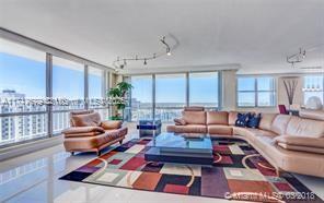 a living room with furniture a rug and a table