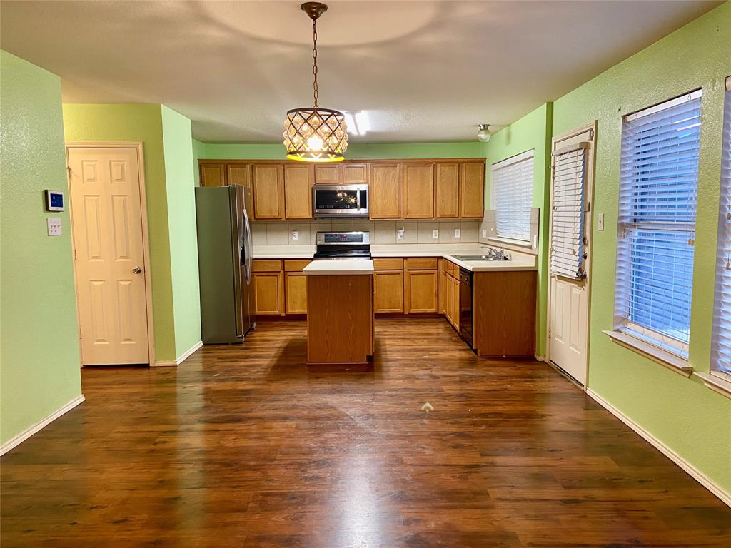 a view of a kitchen with microwave and cabinets