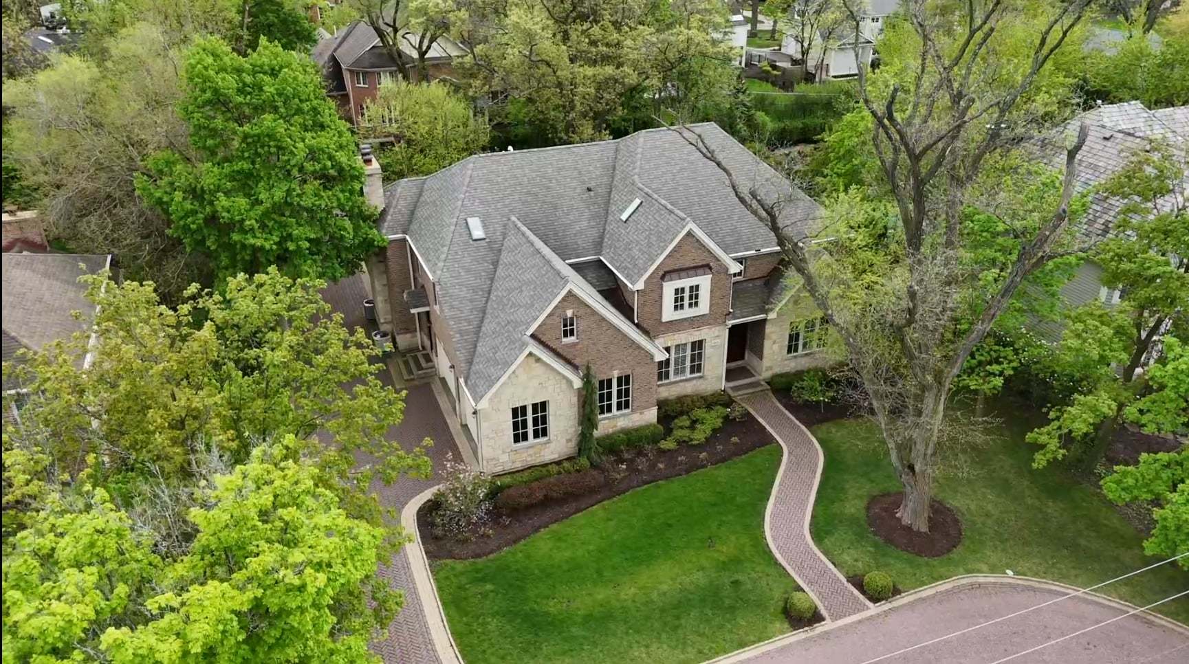 an aerial view of a house with a yard