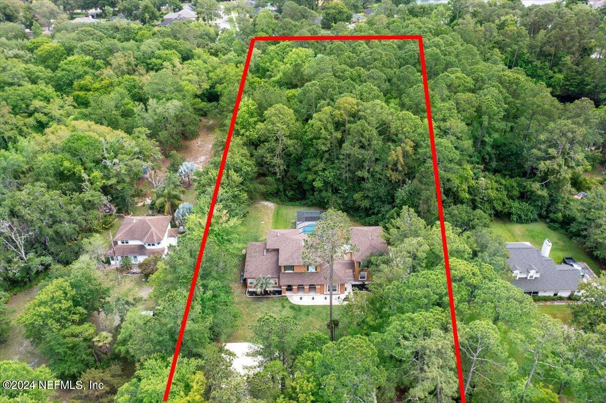 an aerial view of house with yard and outdoor seating