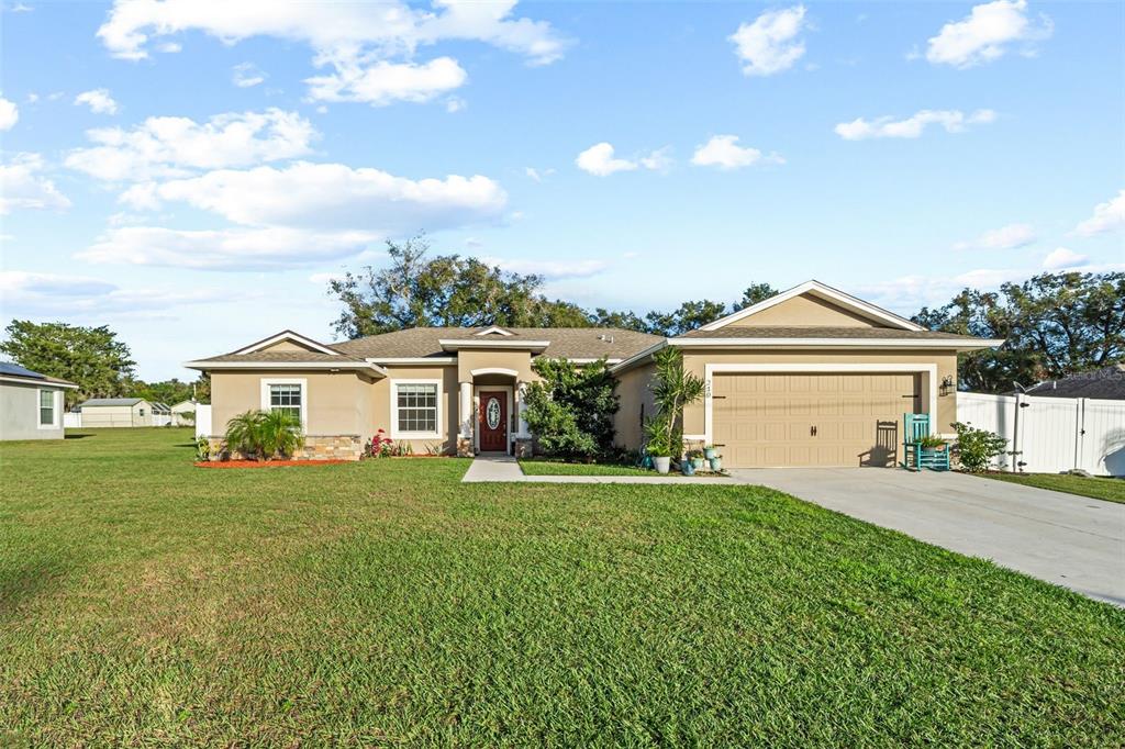 a front view of a house with a yard and garage