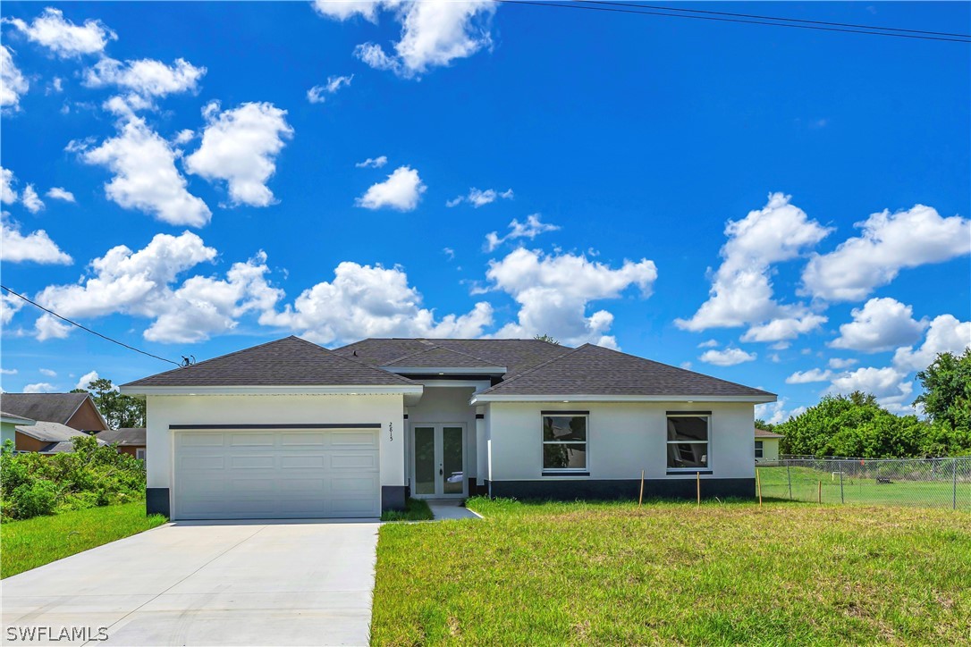 a front view of a house with a yard and garage