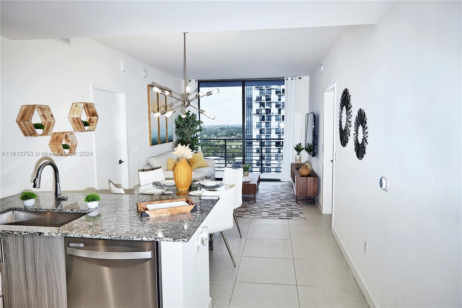 a kitchen with stainless steel appliances granite countertop a sink and a stove