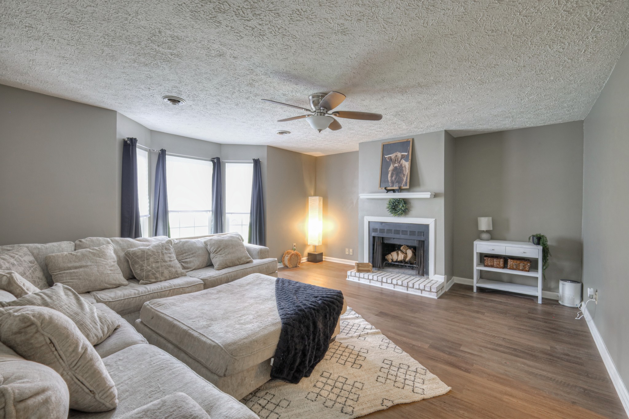 a living room with furniture and fireplace