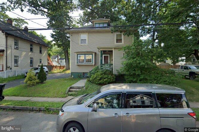 a view of a car parked in front of a house