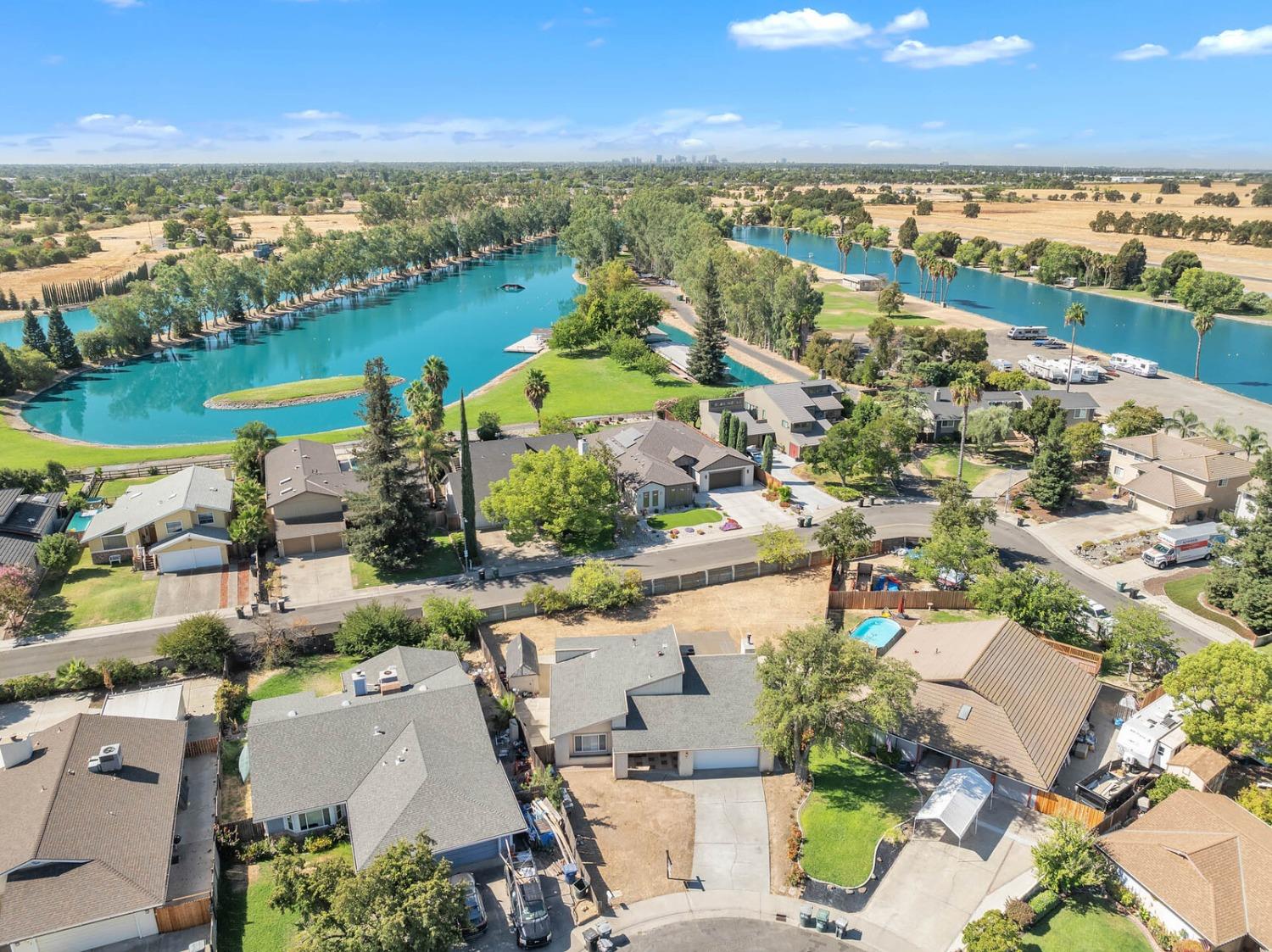 an aerial view of ocean and residential houses with outdoor space