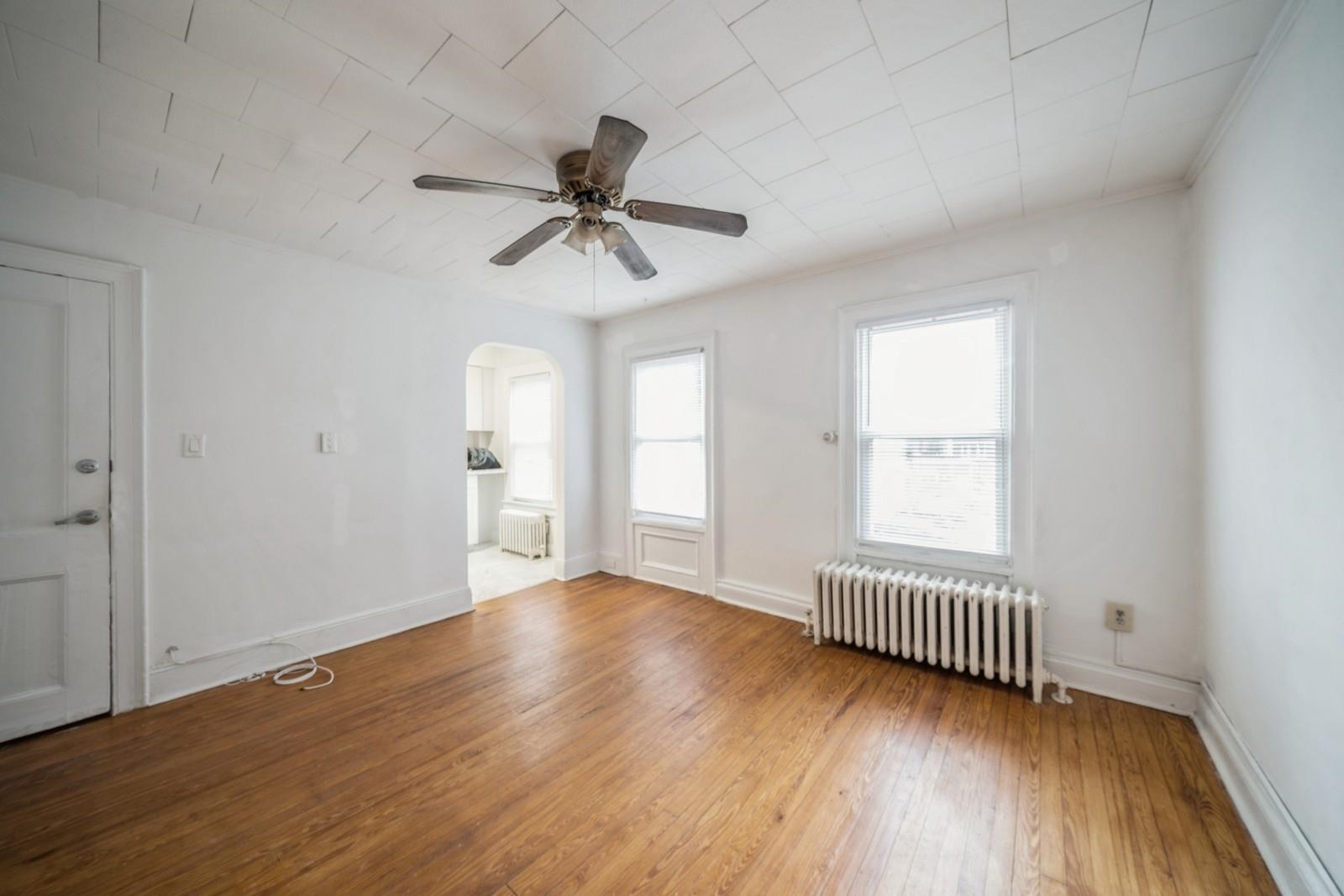 wooden floor in an empty room with a window