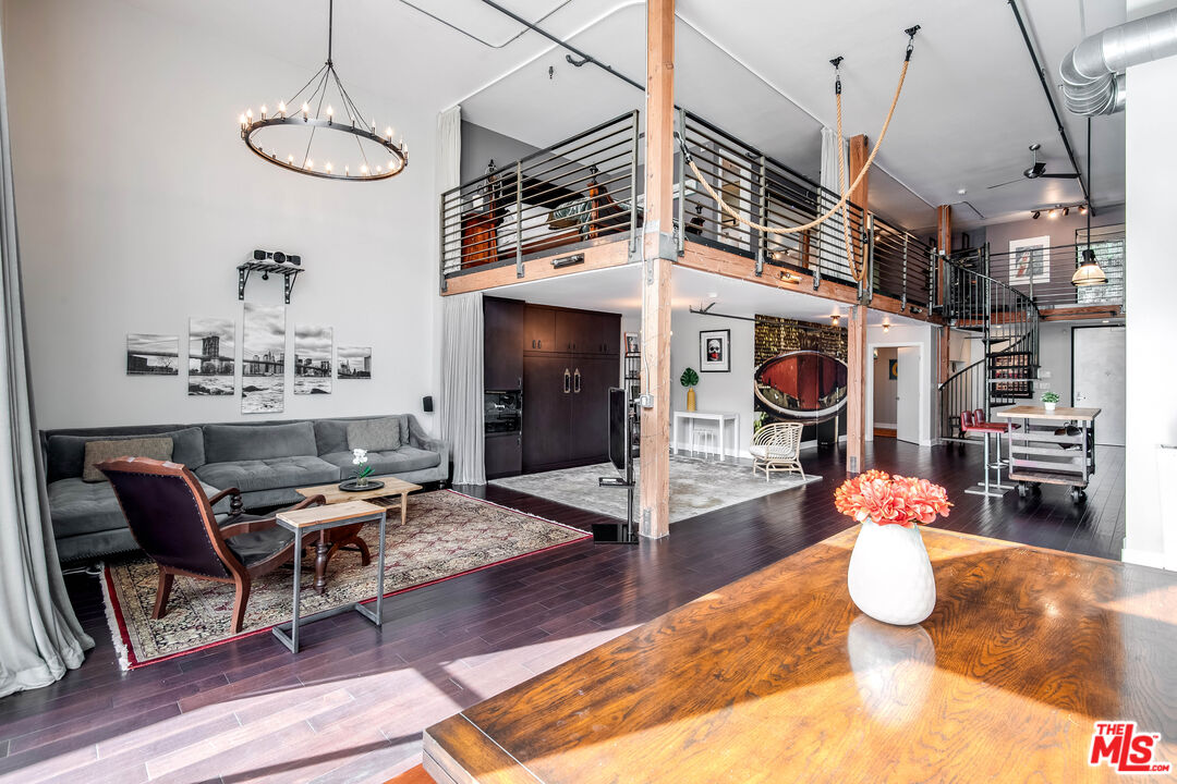 a kitchen with stainless steel appliances kitchen island granite countertop a stove and white cabinets