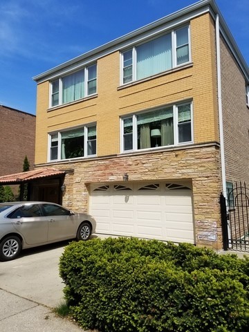 a front view of a house with parking space