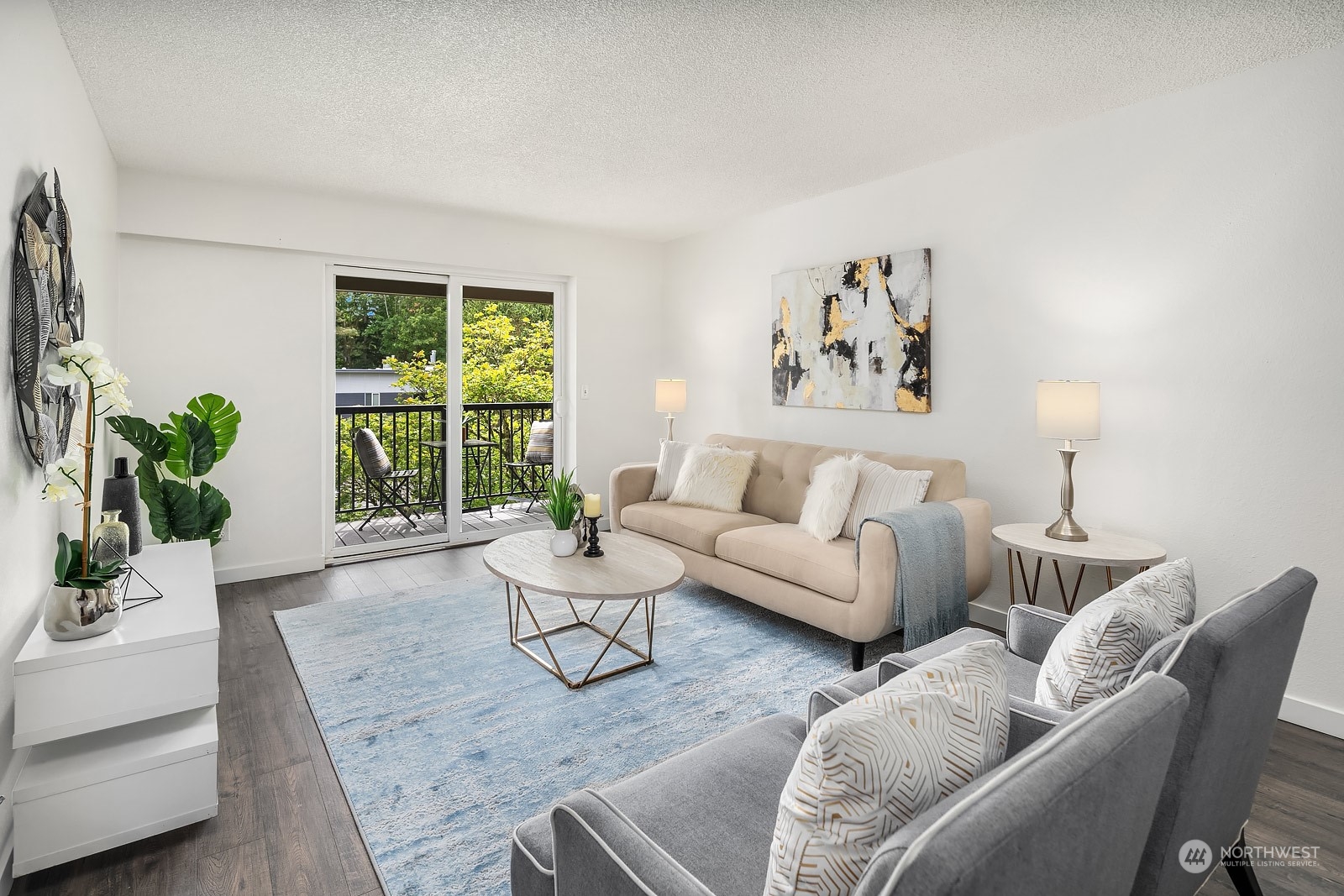 a living room with furniture and a large window with garden view