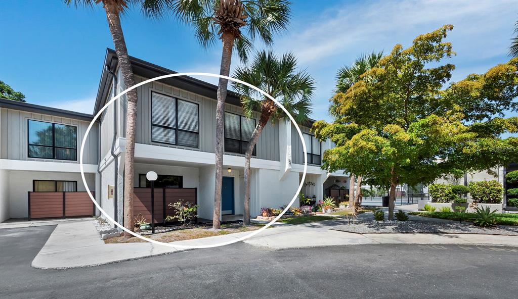 a view of a house with entertaining space and palm trees