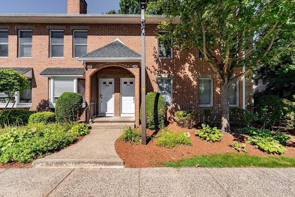 front view of a house with potted plants