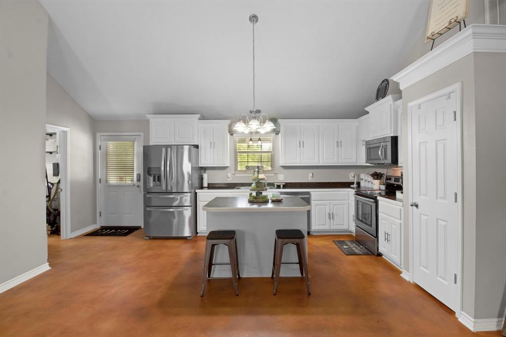 a kitchen with refrigerator and cabinets