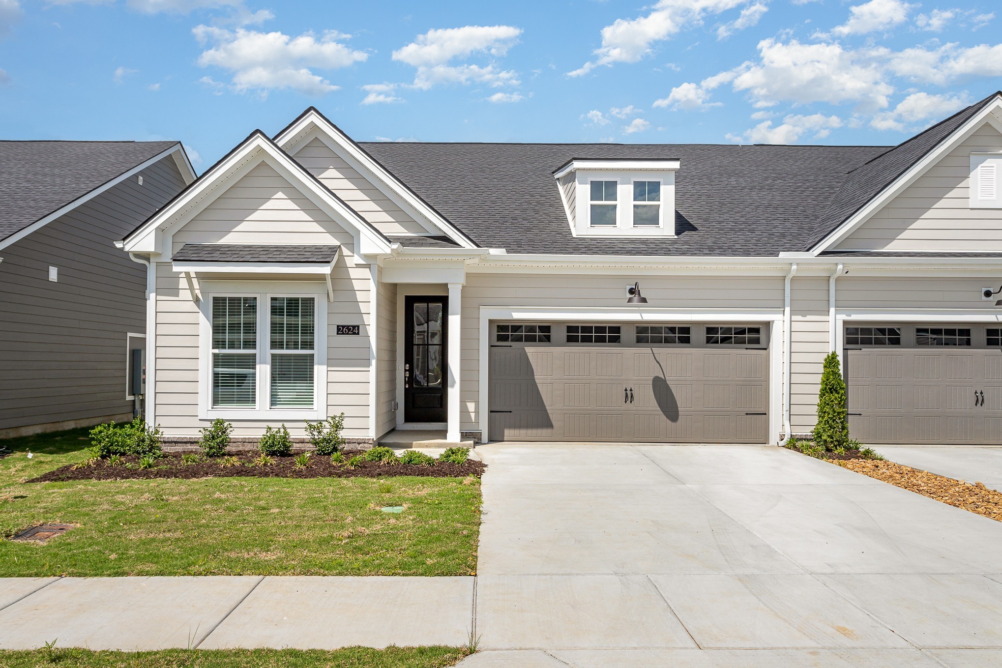 a front view of a house with garden