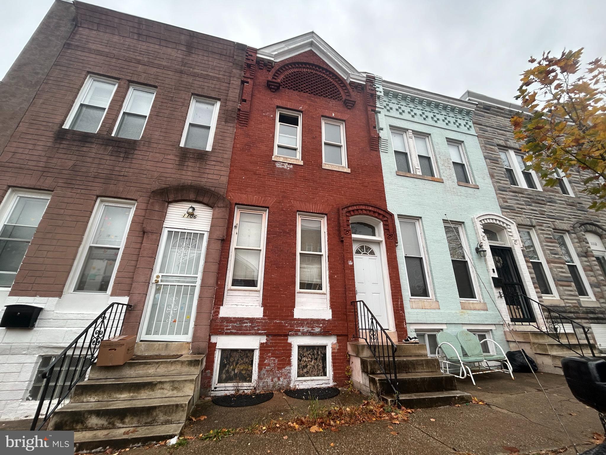 a front view of a residential apartment building with a yard