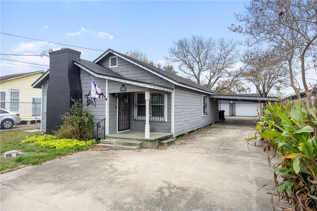 a view of a house with a yard and garage