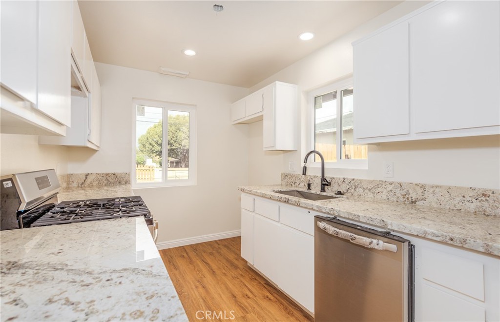 a kitchen with a sink stove and cabinets