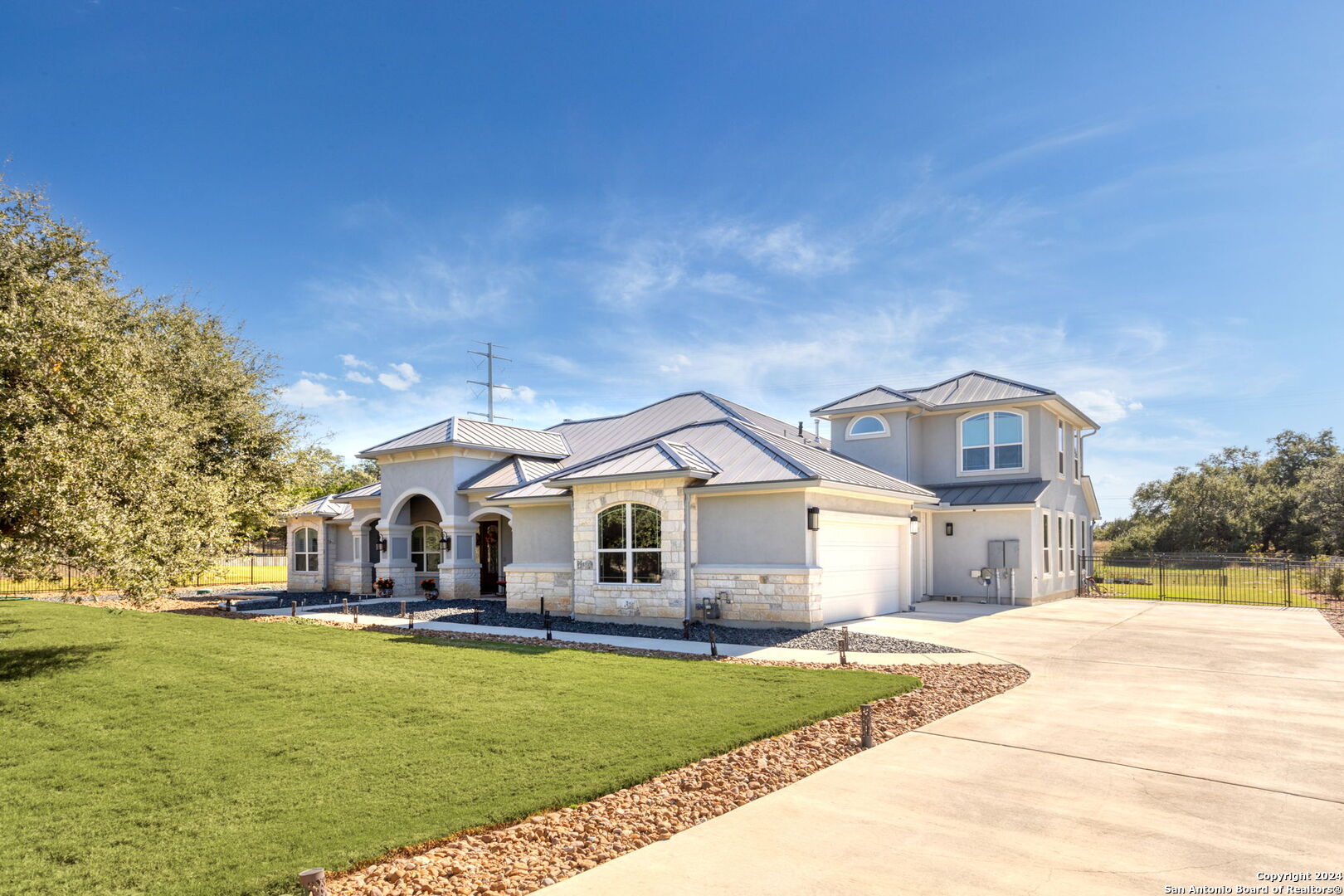 a front view of a house with a garden