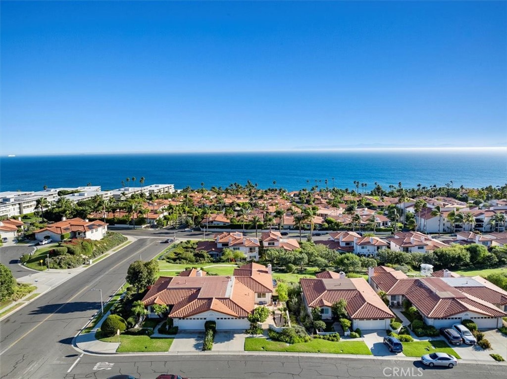 an aerial view of residential houses with city view and ocean view