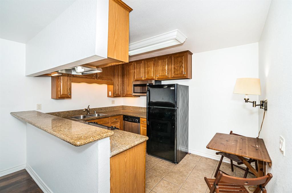 a kitchen with stainless steel appliances granite countertop a sink and a stove