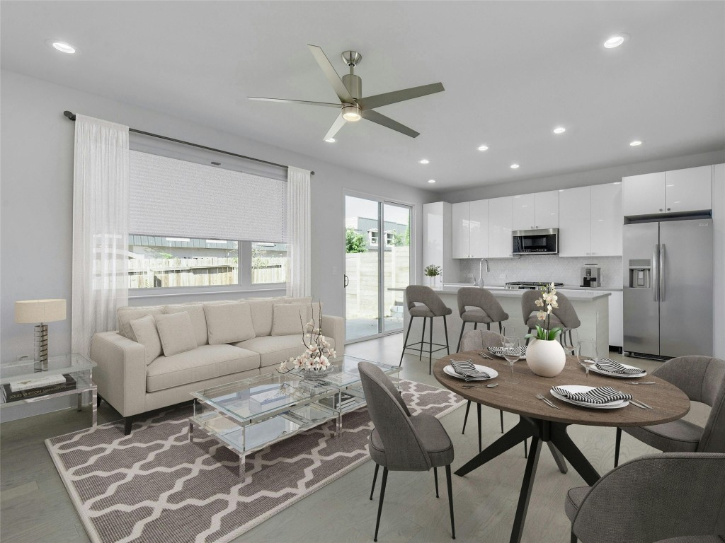 a living room with furniture kitchen view and a window