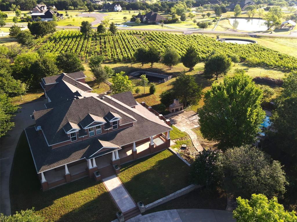 an aerial view of a house with a yard basket ball court and outdoor seating