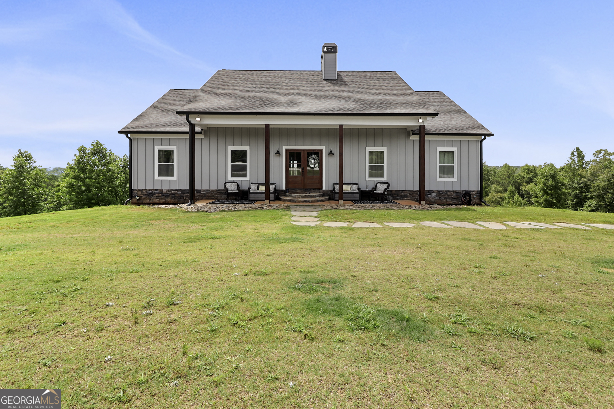 a front view of a house with a garden