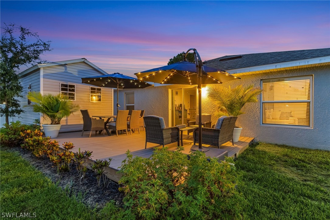 a view of a house with patio and a yard