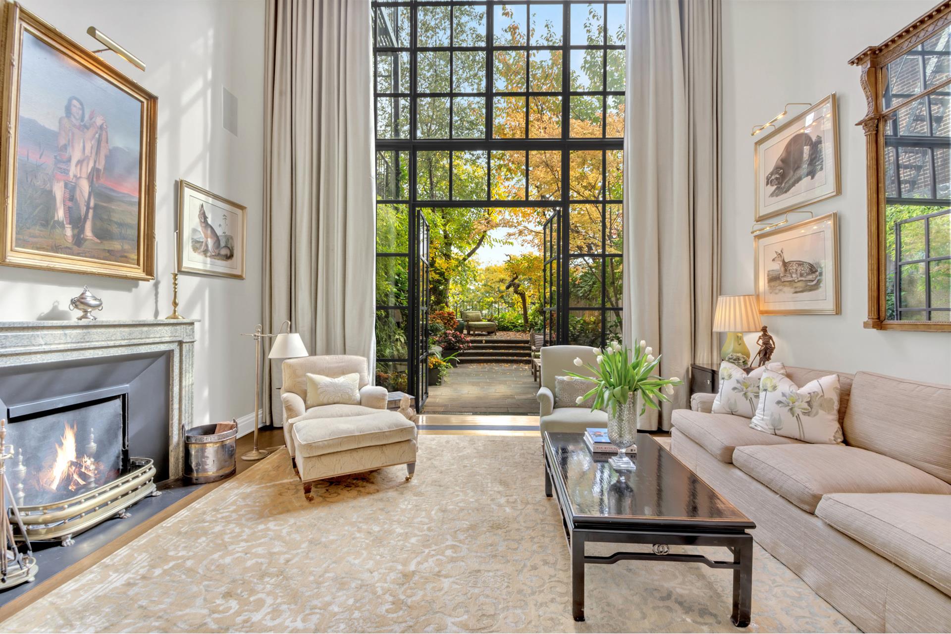 a living room with furniture a fireplace and a large window