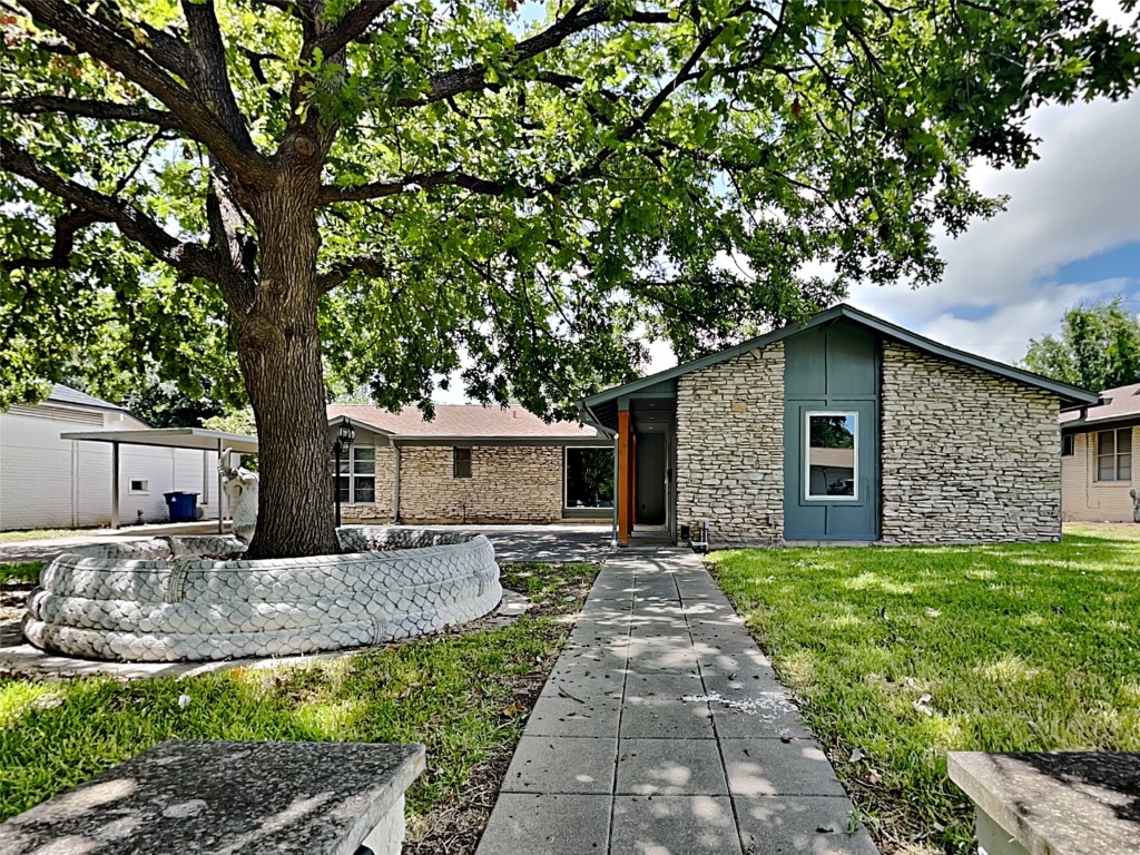 a front view of house with yard and trees