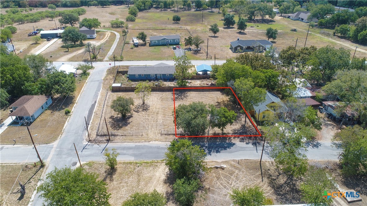 an aerial view of a house with a yard and lake view