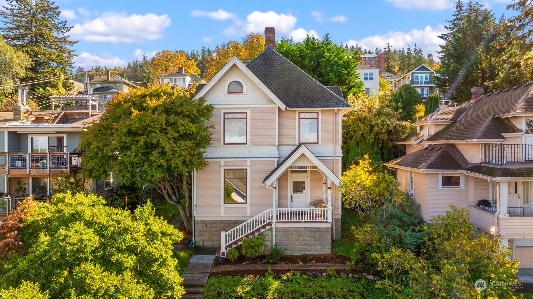 a front view of a house with a yard and trees