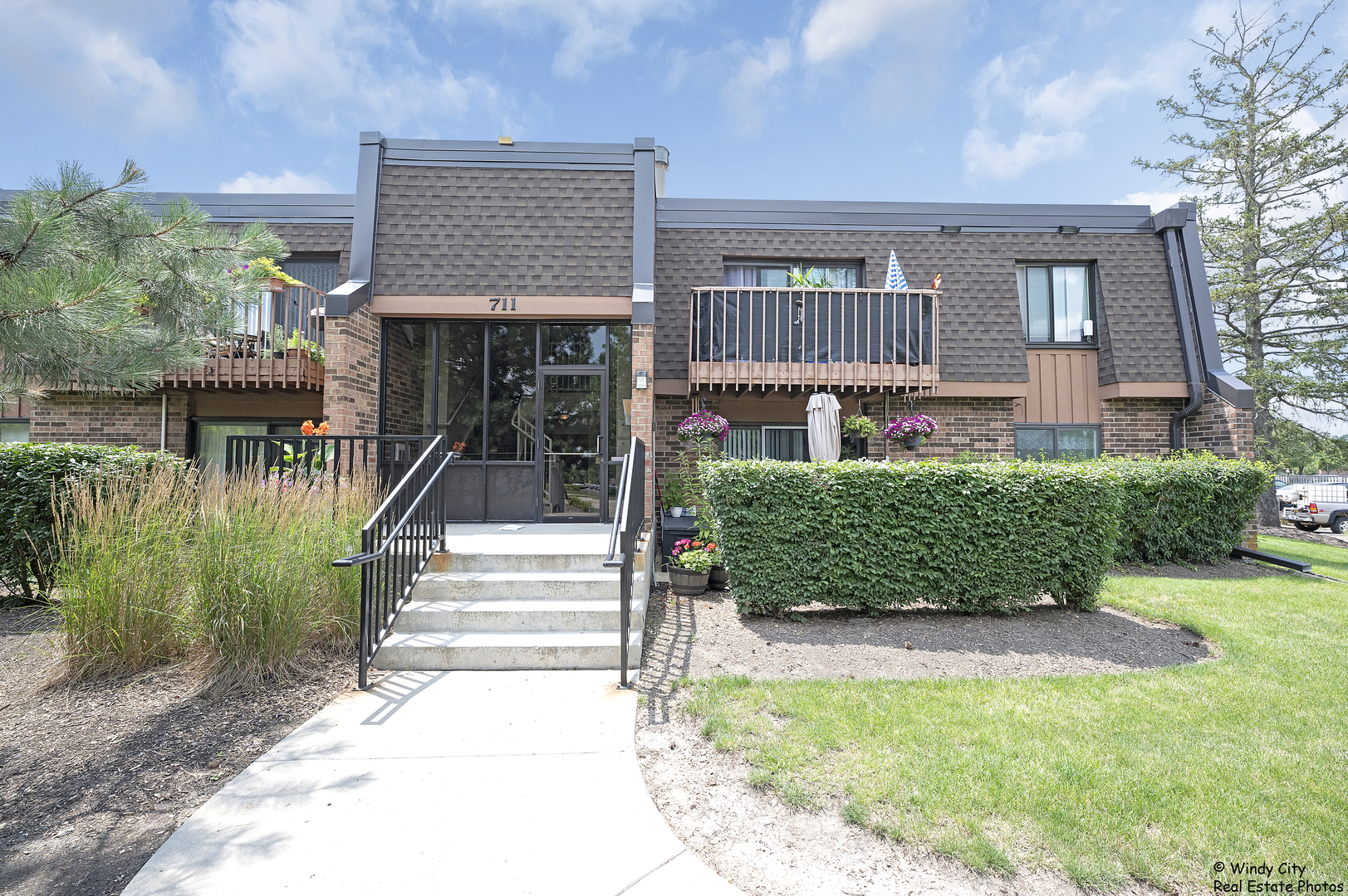 a front view of a house with a garden