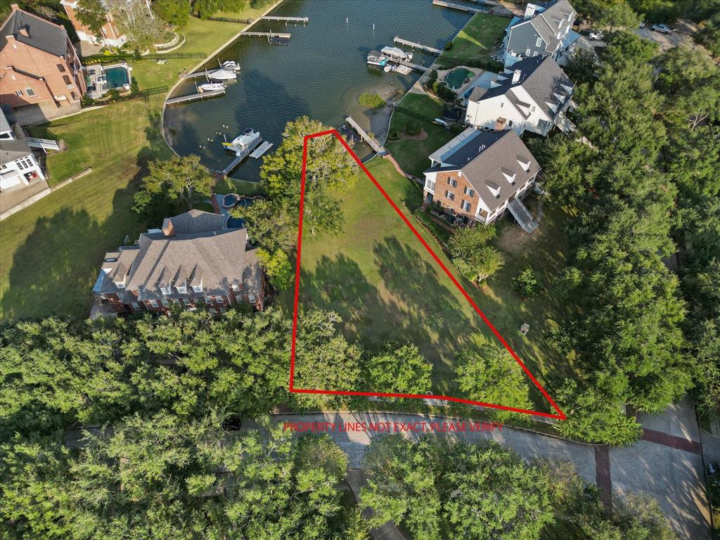 an aerial view of a house a yard and mountain