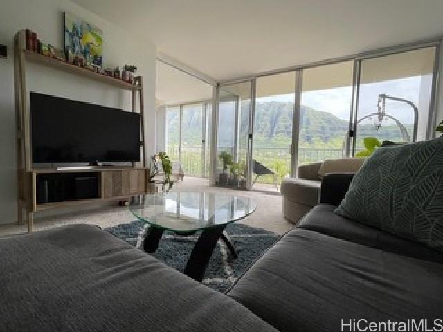 a living room with couches a coffee table and a flat screen tv