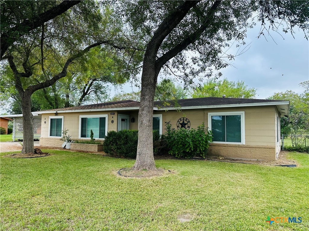 a front view of house with yard and green space