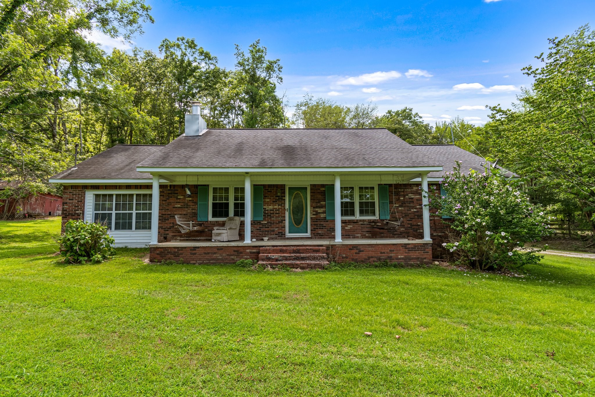 a front view of a house with a yard and porch