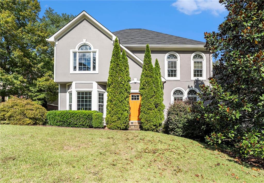 a front view of a house with a yard