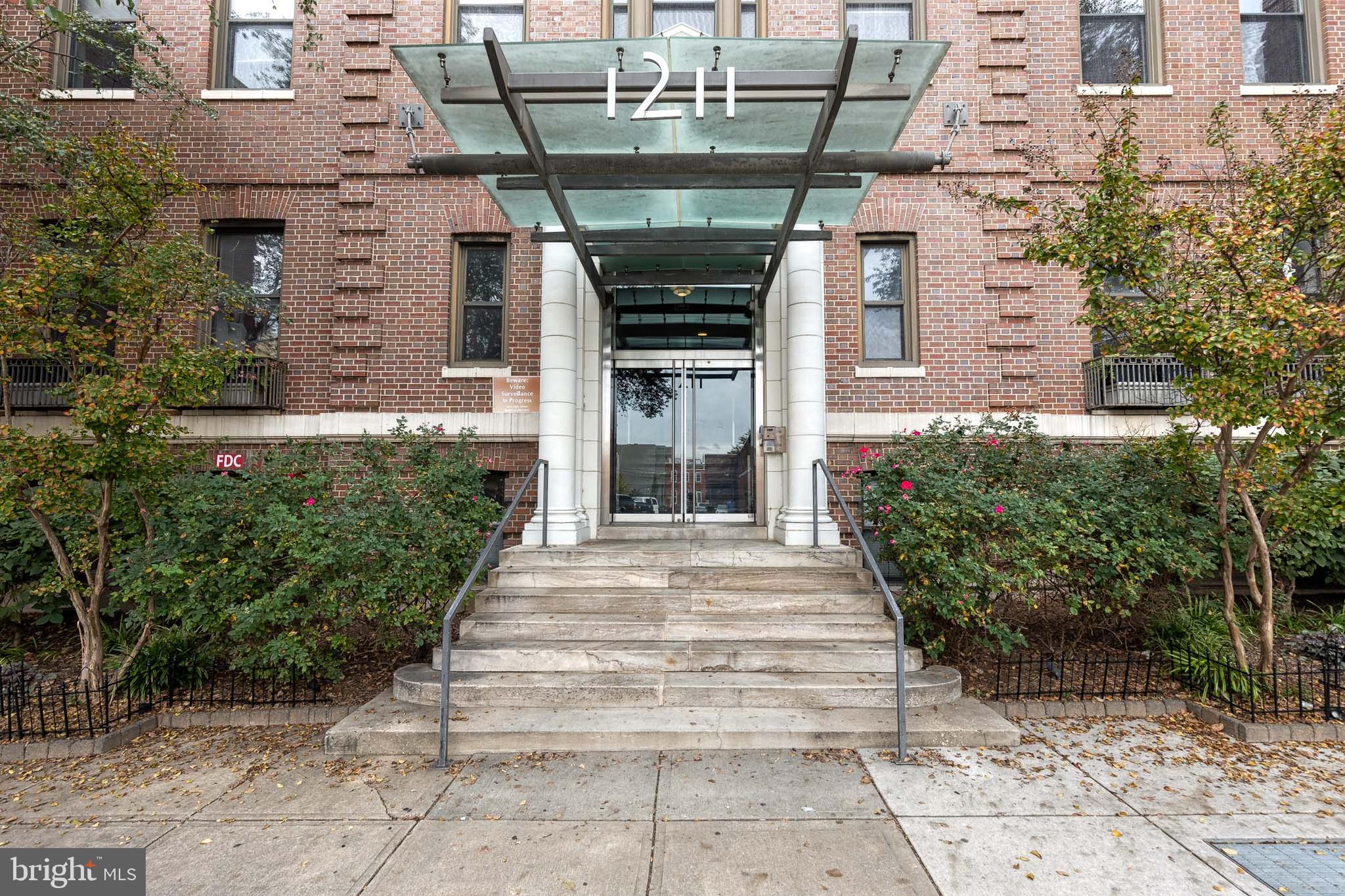 a front view of a building with garden