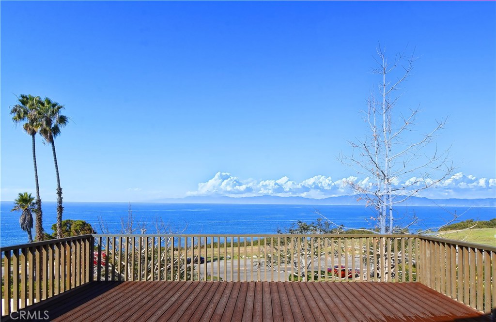 a view of a terrace with wooden floor and fence