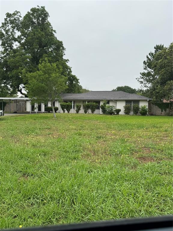 a view of a house with a yard and sitting area