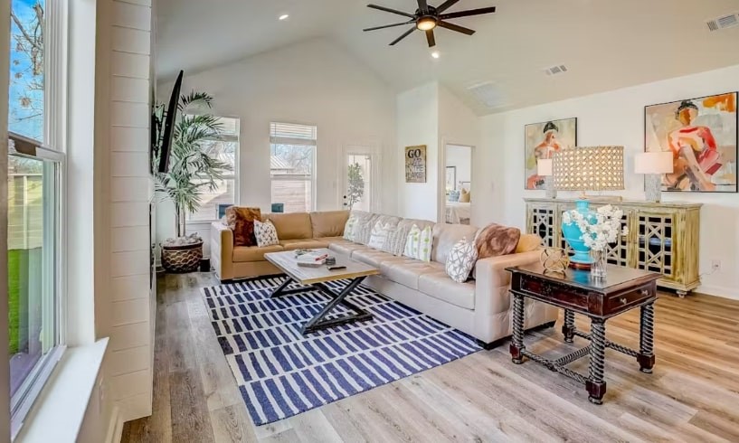 a living room with furniture and wooden floor