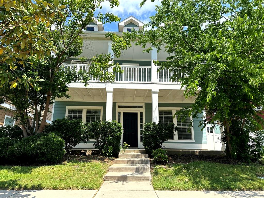 a front view of a house with garden and porch