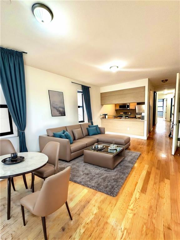 a living room with furniture and a wooden floor