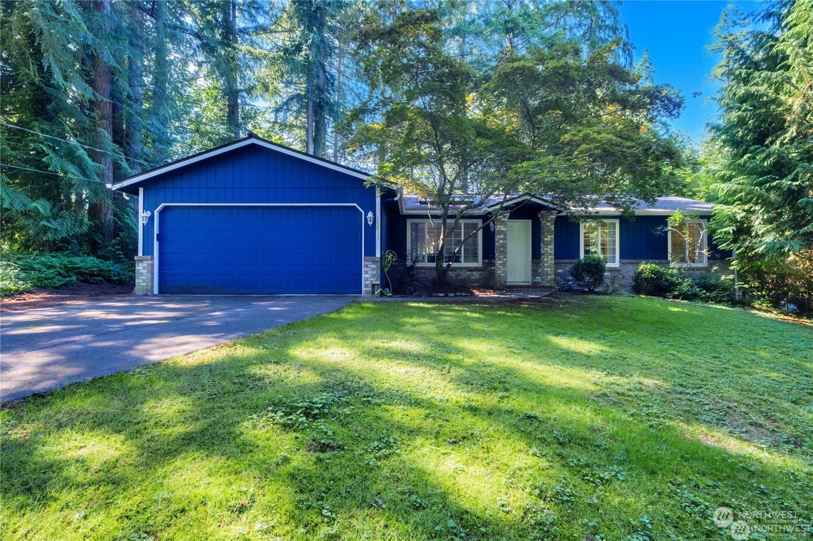 a front view of house with yard and green space