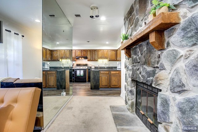 a kitchen with stainless steel appliances granite countertop a sink a stove and a refrigerator